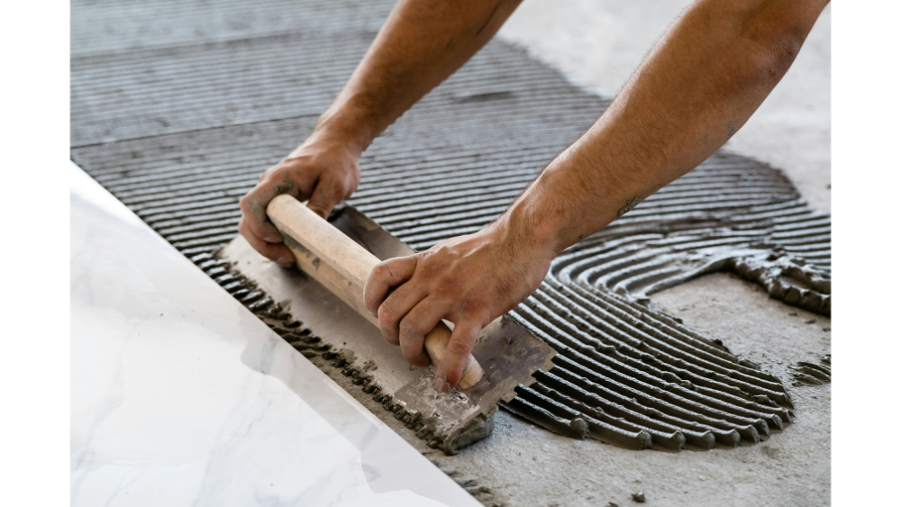 A man installing a tile floor